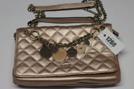 One pre-owned Guess Victoria Quilted Convertible Crossbody pink bag (VG710721. One scratch on the