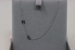 An as new Maya Brenner Asymmetrical letter necklace with two initials (E and N).