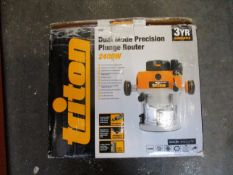A boxed Triton TRA 001 Dual Mode Precision Plunge Router (2400W).