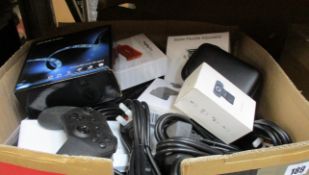 A box of assorted new and pre-owed small electrical items and accessories.