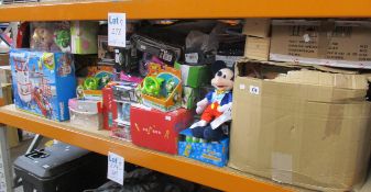 A shelf of as new assorted toys to include Disney soft toys, Playmobil, games, party kits and