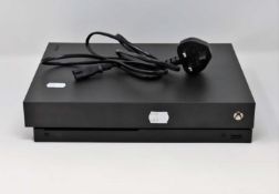 A pre-owned Xbox One X 1TB in Black (Model No: 1878) with adapter (no controllers or other