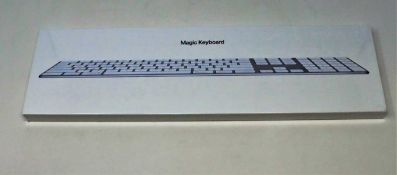 A boxed as new Apple Magic Keyboard MQ052B/A A1843 with Numeric Keyboard (Packaging sealed).