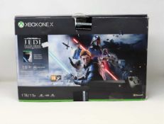 A boxed pre-owned Xbox One X 1TB in Black (Model No: 1878) with adapter and cables (no
