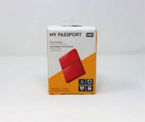 A boxed as-new WD My Passport 4TB Auto Backup Portable Hard Drive in Red (box sealed).