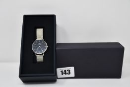 A Daniel Wellington unisex watch with black face and mesh strap (Silver coloured).