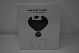 One Theragun Mini ultra portable massage gun.