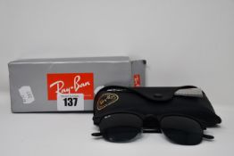 A pair of as new Ray Ban sunglasses.