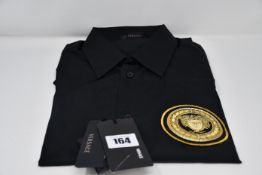An as new Versace black shirt with logo (Size 38 - RRP £145).