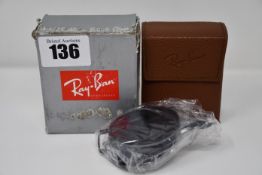 A pair of as new Ray Ban folding RB3517 sunglasses.