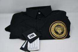 An as new Versace black shirt with logo (Size 39 - RRP £145).