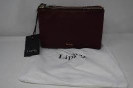 An as new Lipault Invitation multi pouch bag in burgundy.