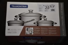Two boxed as new Tramontina trio sets of stainless steel pans with lids.