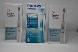 Two Spotlight Oral Care Sonic and one Philips Sonicare 4300 Protective Clean electric toothbrush,