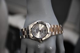 A men's pre-owned Tag Heuer Aquaracer WAF1112 stainless steel watch.