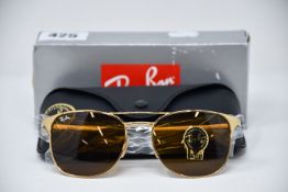 A pair of as new Ray Ban sunglasses.