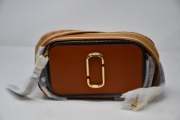 An as new Marc Jacobs Snapshot bag in skyline brown (RRP from £300).