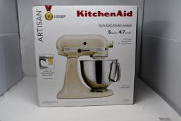 A boxed Kitchen Aid Stand Mixer in almond cream (KSM150PSAC).