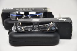 Two pairs of as new Oakley glasses frames with clear glass; Chamfer and Socket 5.5.