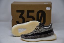 A pair of infants Adidas Yeezy Boost 350 V2 trainers (UK 9.5K).