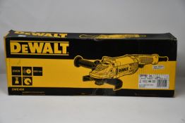 A boxed Dewalt DWE490 angle grinder.