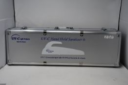 An as new UV - C hand held sanitizer (Powerful 24W) contained in a metal carry case.