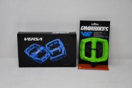 Three as new DMR Versa pedals sets in black together with one DMR V6 green pedal set.