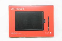 A boxed as new Wacom One Medium Graphics Tablet and Pen in Black & Red (Box sealed).