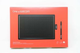 A boxed as new Wacom One Medium Graphics Tablet and Pen in Black & Red (Box sealed).
