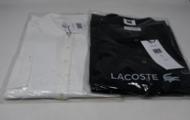 Two as new Lacoste polo shirts; black (Size 46) and white (Size 36).