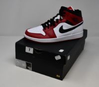 A pair of as new Nike Air Jordan Mid 1 trainers (UK 9).