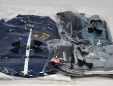 Five items of as new Under Armour sportswear; Storm Windstrike 1/2 zip, Storm full zip jacket, Storm