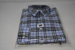An as new Burberry check shirt in sky blue (M).