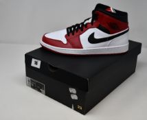 A boxed as new pair of Nike Air Jordan 1 Mid white and red basketball shoes (UK 11).