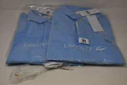 Two as new Lacoste polo shirts (US L and 3XL).