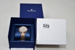 A ladies boxed as new Swarovski Crystaline Glam Watch with metal bracelet (White rose gold tone).