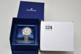 A ladies boxed as new Swarovski Crystaline Glam Watch with metal bracelet (White, stainless steel).