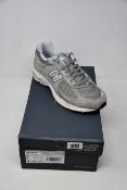 A pair of as new New Balance 2002R light grey (UK 7.5).