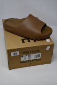 A pair of as new Adidas Yeezy Slide (UK 9).