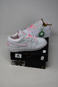 A pair of as new Nike Air Jordan 1 Low trainers (UK 4).