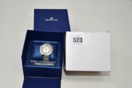 A ladies boxed as new Swarovski Crystaline Glam Watch with metal bracelet (White, stainless steel).
