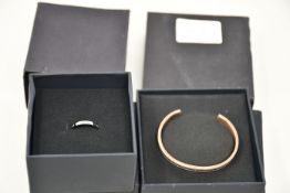 A Daniel Wellington cuff bangle (N15RWO4) and a Daniel Wellington band ring.