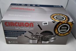 A boxed as new Circulon Momentum stainless steel 5-piece pan set.