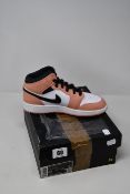 A pair of as new Nike Air Jordan 1 Mid trainers (UK 4).