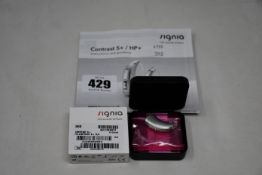 A boxed as new Signia Contrast S+ hearing aid in silver.