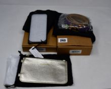 An as new Bandolier iPhone 7 case in metallic gold with matching strap and leather pouch,