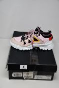 A pair of boxed as new Alexander McQueen MCQ Orbyt Mid Sneakers in black and bubblegum pink (EU
