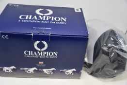 Two as new Champion horse riding helmets to include Champion De-Lux leather harness in black and