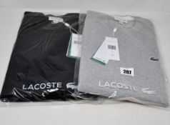 Two as new Lacoste sweaters (US L).