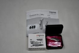 A boxed as new Signia Contrast S+ hearing aid in silver.